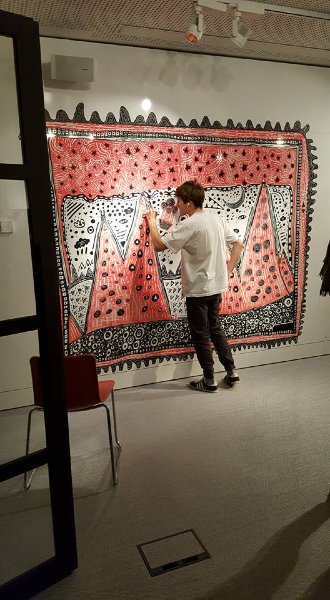 Space Raphaël creating a large original artwork during an exhibition