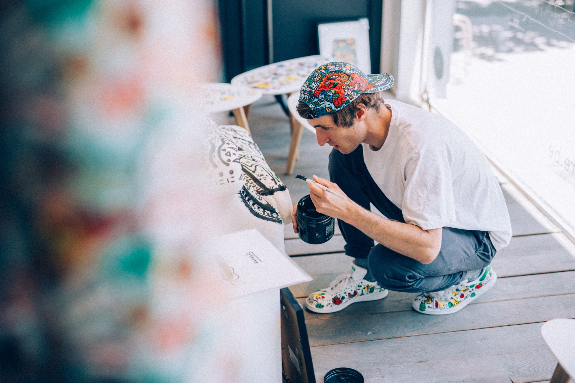 Space Raphaël painting a chair by hand