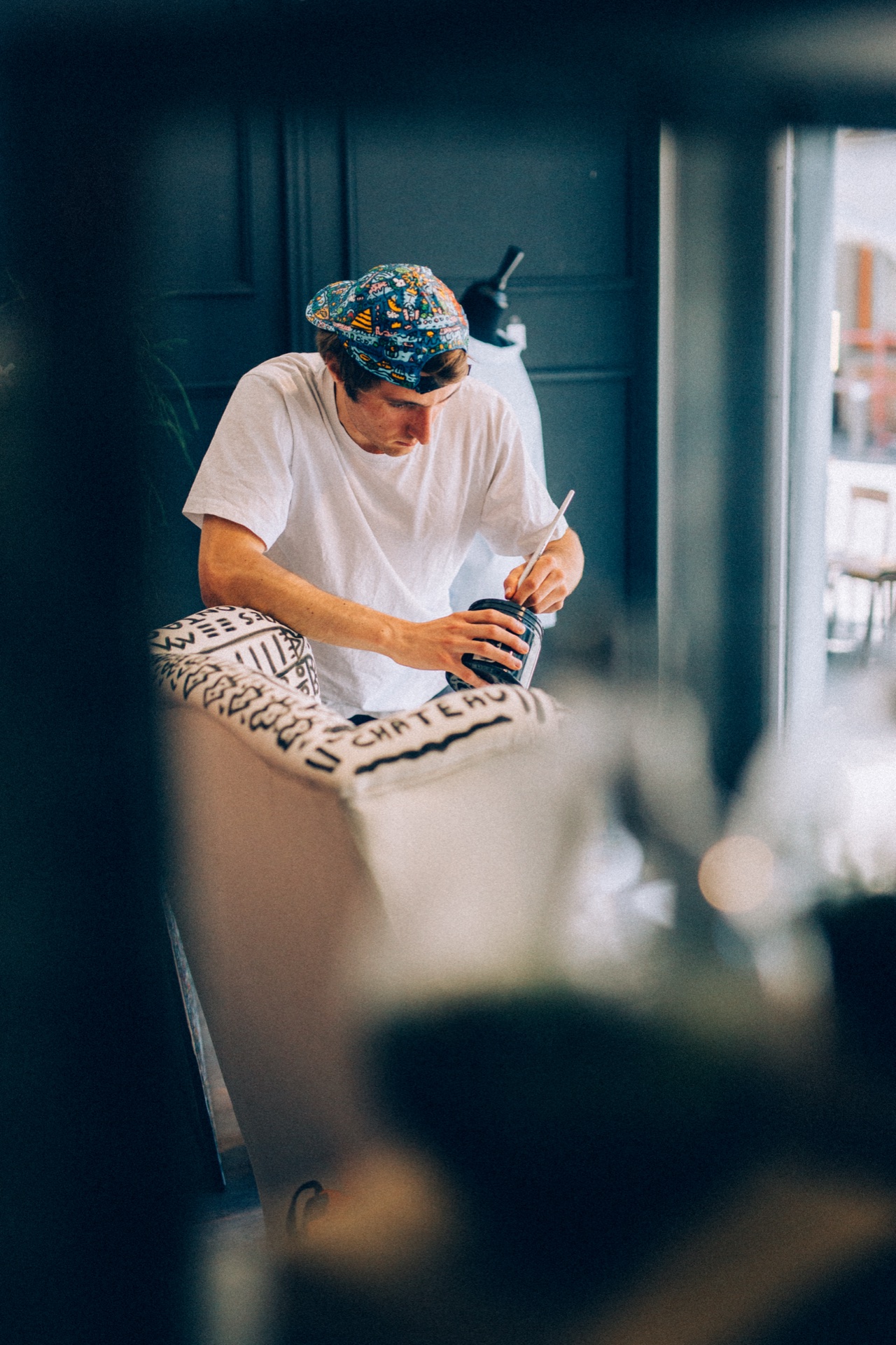 Space Raphaël adding black linework to a painted chair