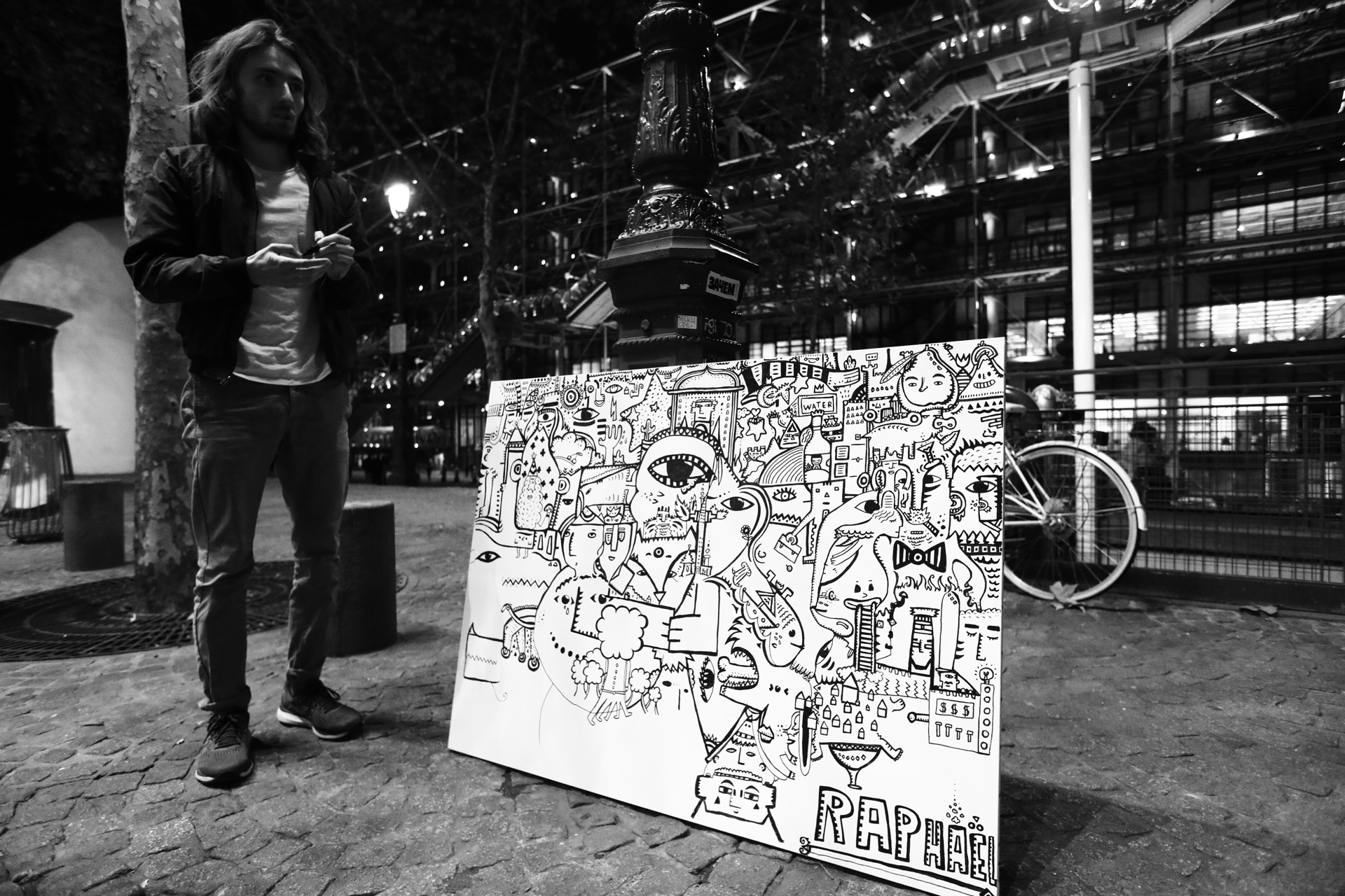 Space Raphaël presenting a black and white artwork at night