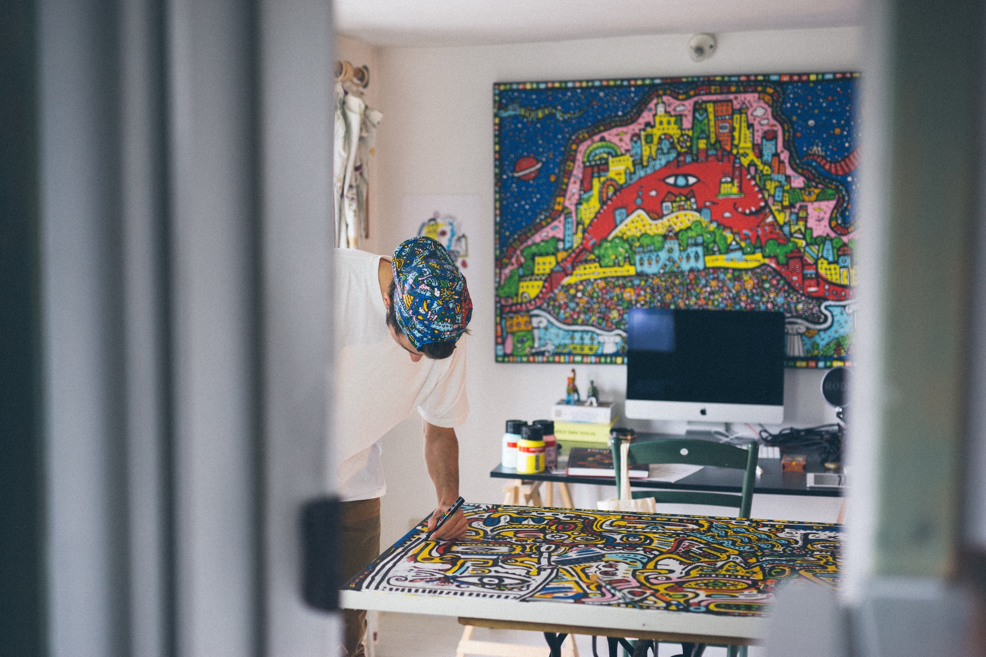 Space Raphaël painting a colorful original artwork in the studio